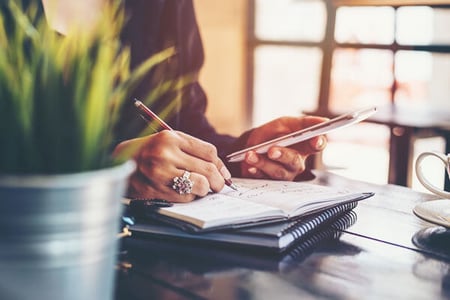 photo of person writing a list on a notepad