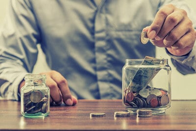 man moving money from one pot to another