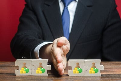 Man splitting a puzzle of money with his hand
